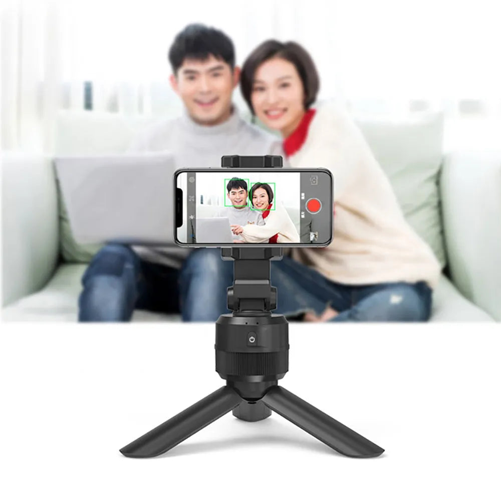 Black 360 degree rotating mobile phone holder on a desk, ABS construction with full rotation capability