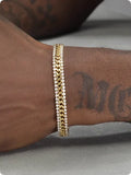 Gold tennis bracelet with electroplated finish and artificial gemstone inlay on titanium steel