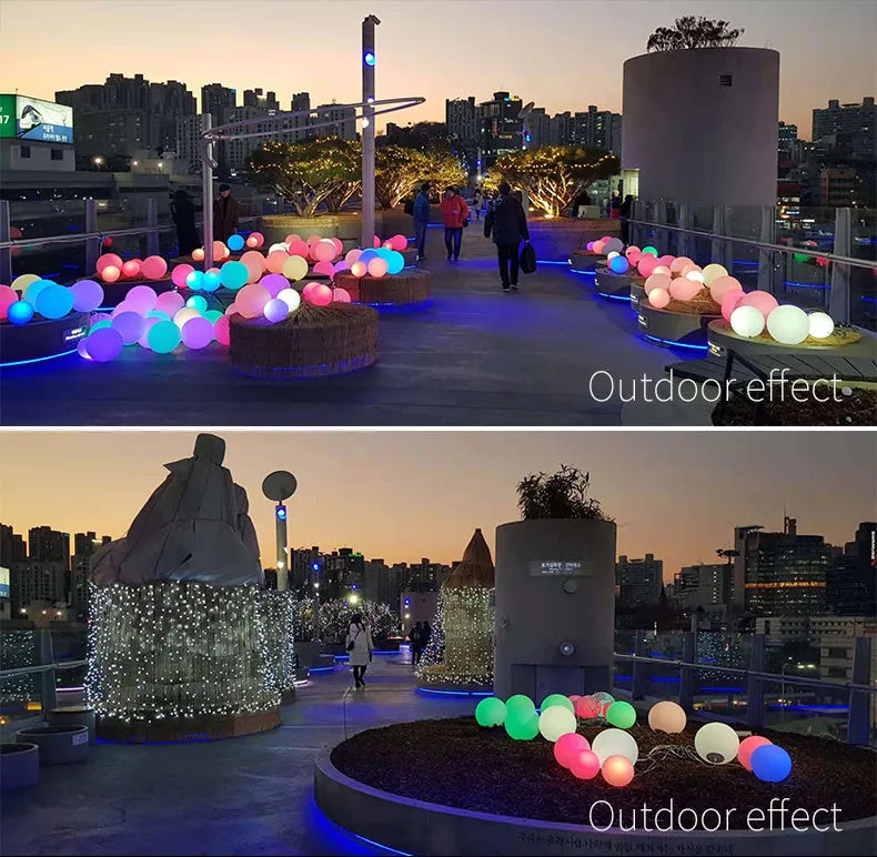 Spherical blue LED garden floor lamp with remote control sitting on grass.