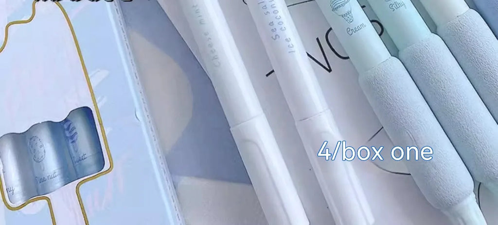 Set of four double-headed fluorescent pens for student calligraphy practice on a desk.