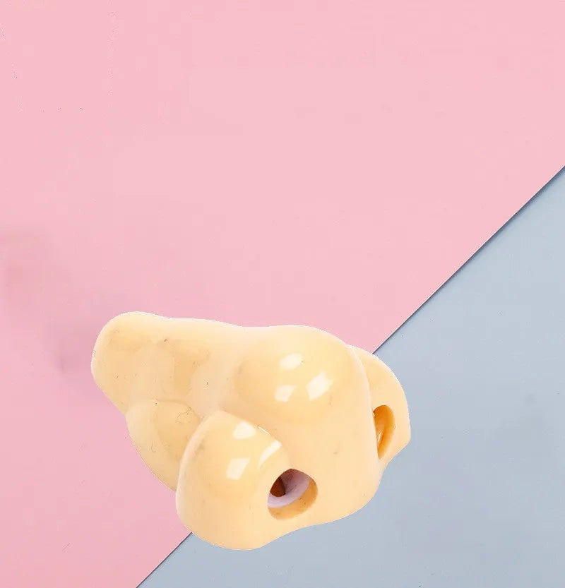Flesh-coloured geometry-shaped plastic pencil sharpener with big nostril for standard pencils.