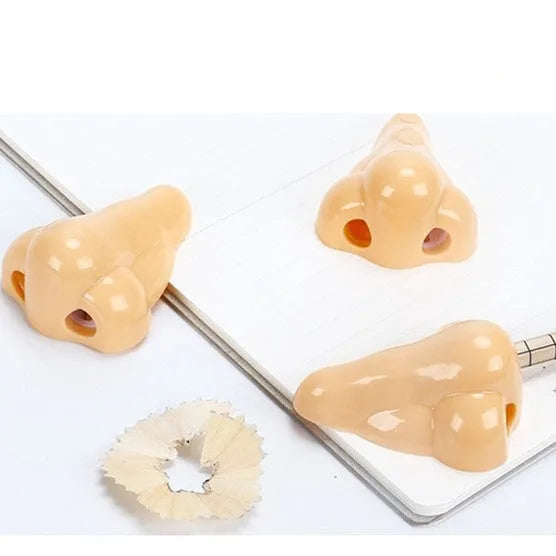 Flesh-coloured geometry-shaped plastic pencil sharpener with big nostril for standard pencils.