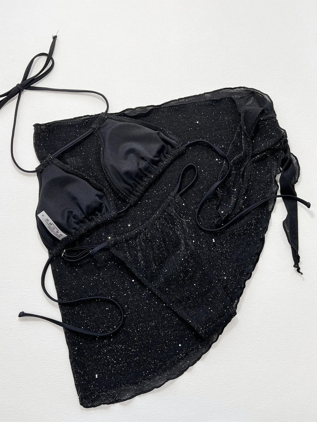 Black three-piece bikini swimsuit set with top and shorts on a mannequin.