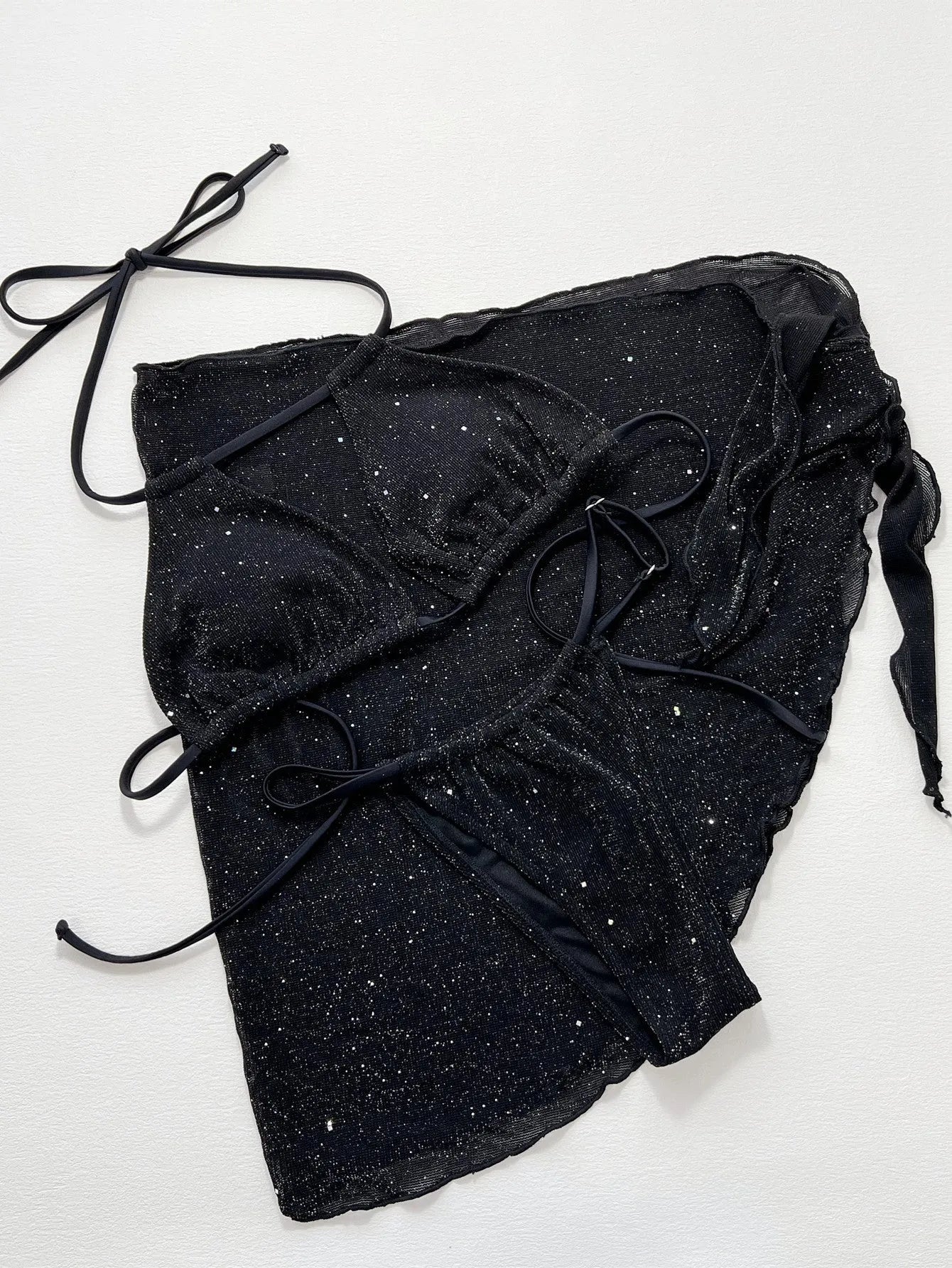 Black three-piece bikini swimsuit set with top and shorts on a mannequin.