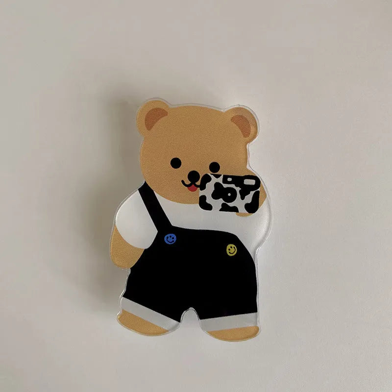White epoxy resin Brown Bear series phone bracket with bear holding flower design on desk