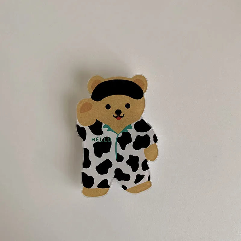 White epoxy resin Brown Bear series phone bracket with bear holding flower design on desk