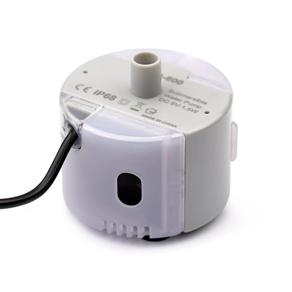 Cylindrical plastic pet water pump with three cleaning brushes on a white background