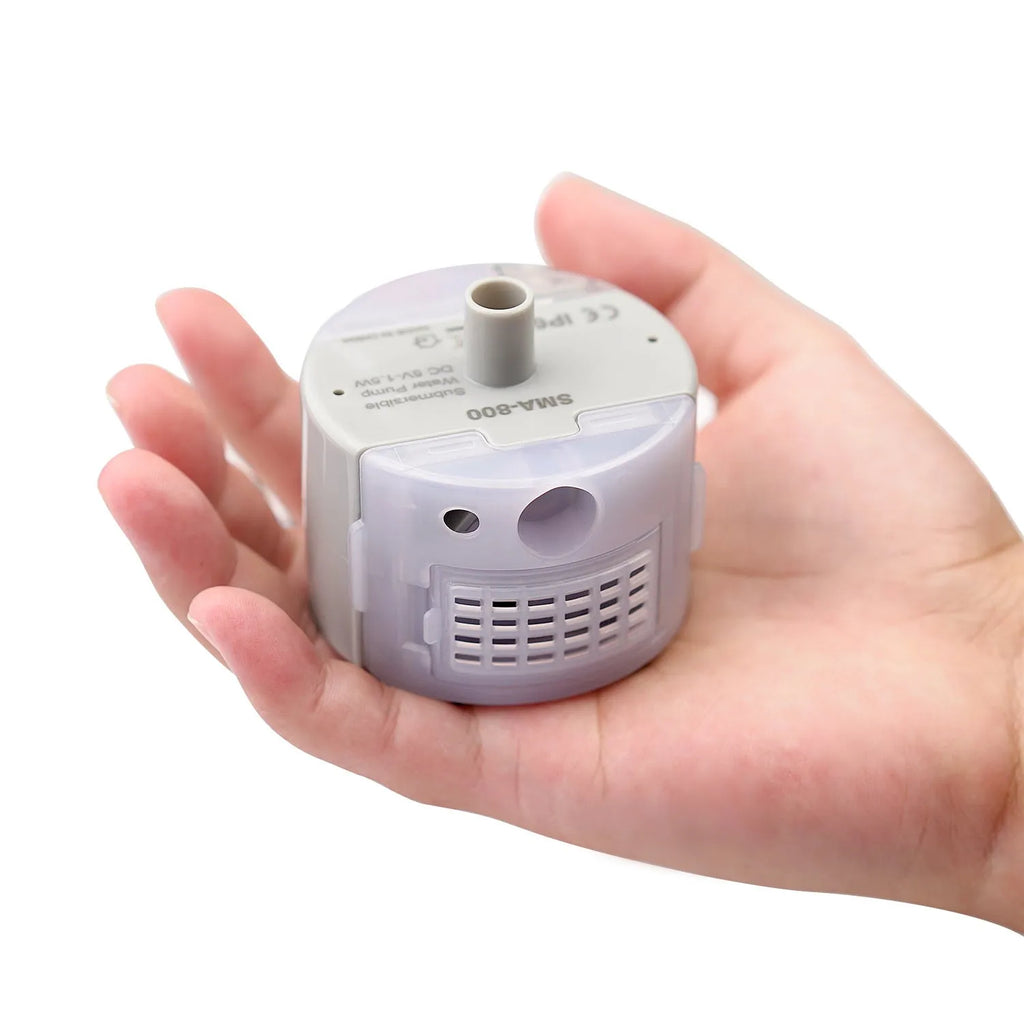 Cylindrical plastic pet water pump with three cleaning brushes on a white background