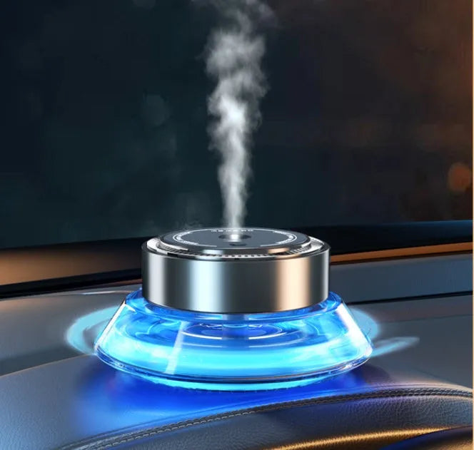 Black smart automatic spray car air freshener device with a 50 ml refill cartridge mounted on a car vent.