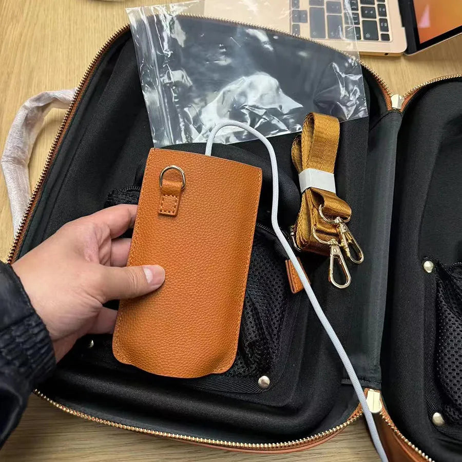 Brown leather battery power shoulder strap protective cover on a black strap, front view