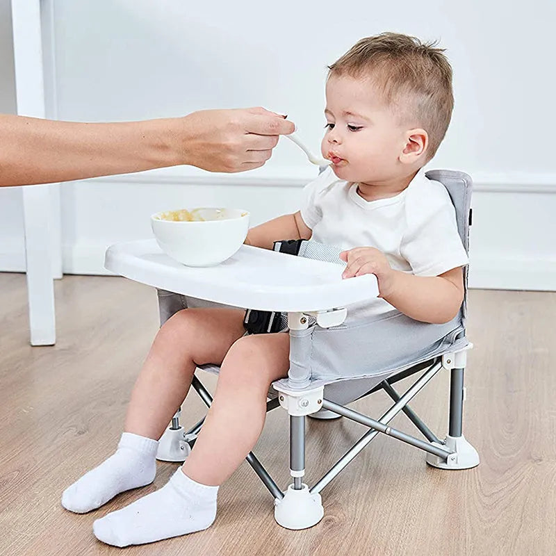 Foldable baby dining chair in folding grey with removable tray and safety belt, includes storage bag