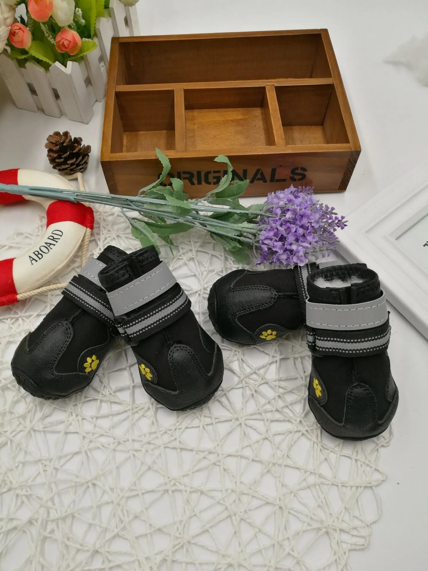 Black dog shoes with waterproof PVC sole and adjustable fuzzy belt on a white background