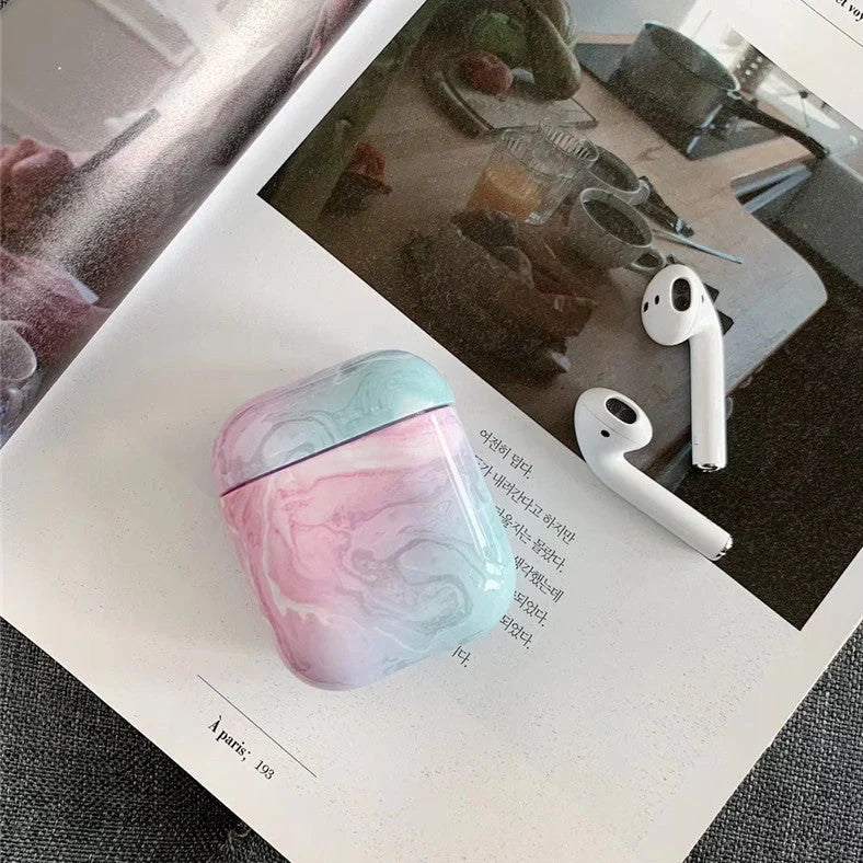 White marble pattern AirPods protective case with hard PC construction showing charging port access