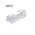 Transparent self-adhesive plastic cable management clips in four sizes on a white background.