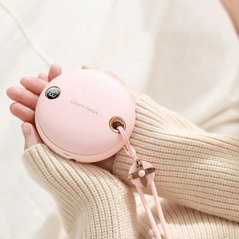 Green hand warmer power bank with digital display showing battery percentage