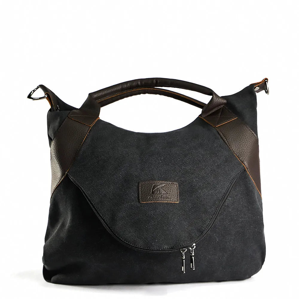 Women's canvas handbag in lake blue with zipper closure, hard handle, and double strap roots for shoulder or crossbody carry