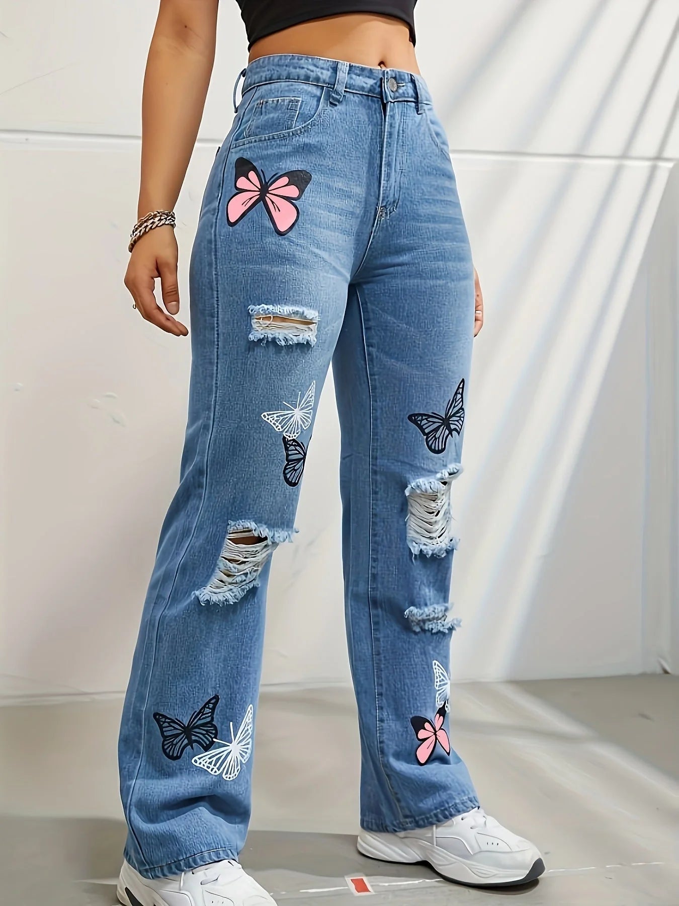 Women's high-waisted straight-leg jeans with butterfly print and distressed details