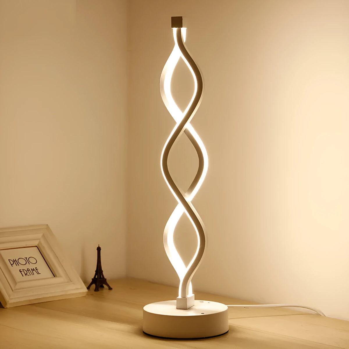 Gold LED desk lamp with acrylic shade and aluminium body on a desk
