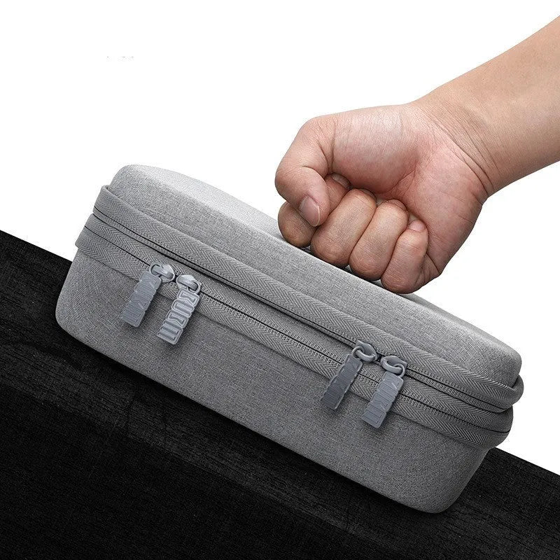 Black EVA digital storage bag shaped like a handbag for organising headphones and cables.