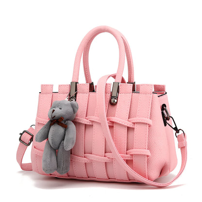 Women's black PU leather shoulder handbag showing four internal organisational compartments and adjustable strap