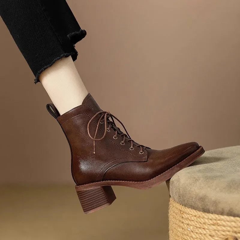 Women's black pointed-toe short tube boots with 5.5cm block heel on wooden floor