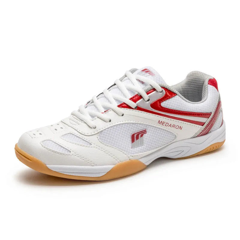 White and red mesh table tennis sneakers with rubber sole and lace-up front.