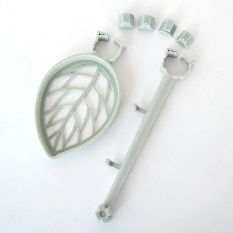 Clip-on adjustable sink drain basket in pink and light green, organising soap and towels