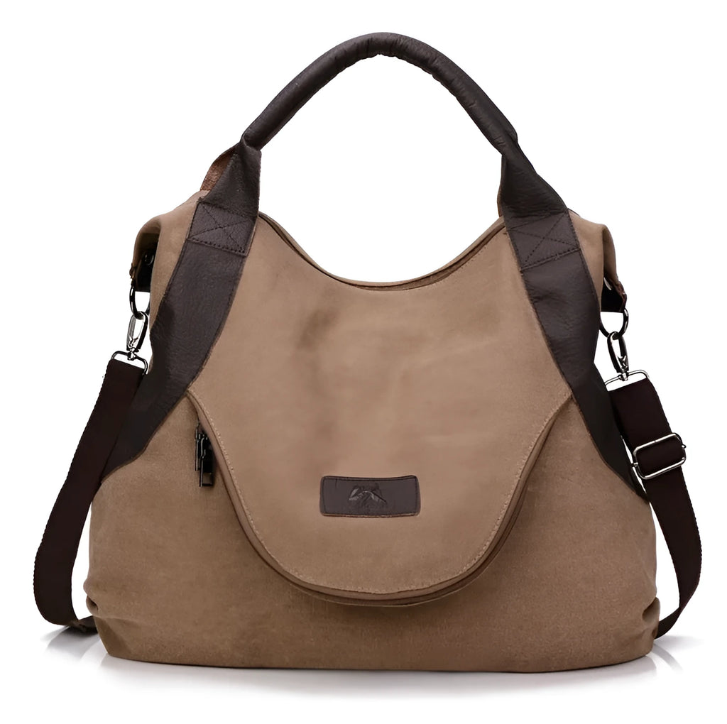 Women's canvas handbag in lake blue with zipper closure, hard handle, and double strap roots for shoulder or crossbody carry