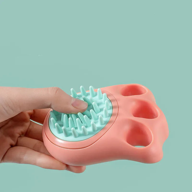 Cat claw-shaped silicone pet bath brush with suction cup base, shown in blue colour.