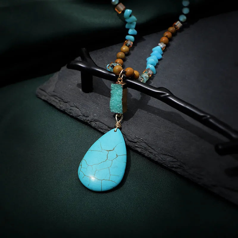 Turquoise water drop shaped pendant necklace with mixed gem inlaid detailing on ball bead chain