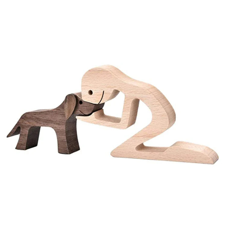 Handcrafted wooden dog sculpture featuring a man and his loyal canine companion