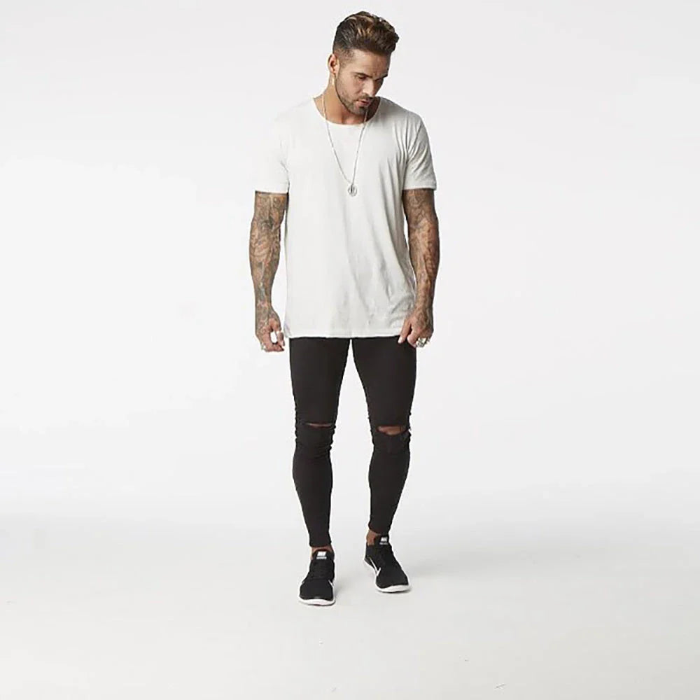 Premium distressed men's slim-fit jeans in black, featuring a stretchy mid-rise design and edgy, on-trend detailing