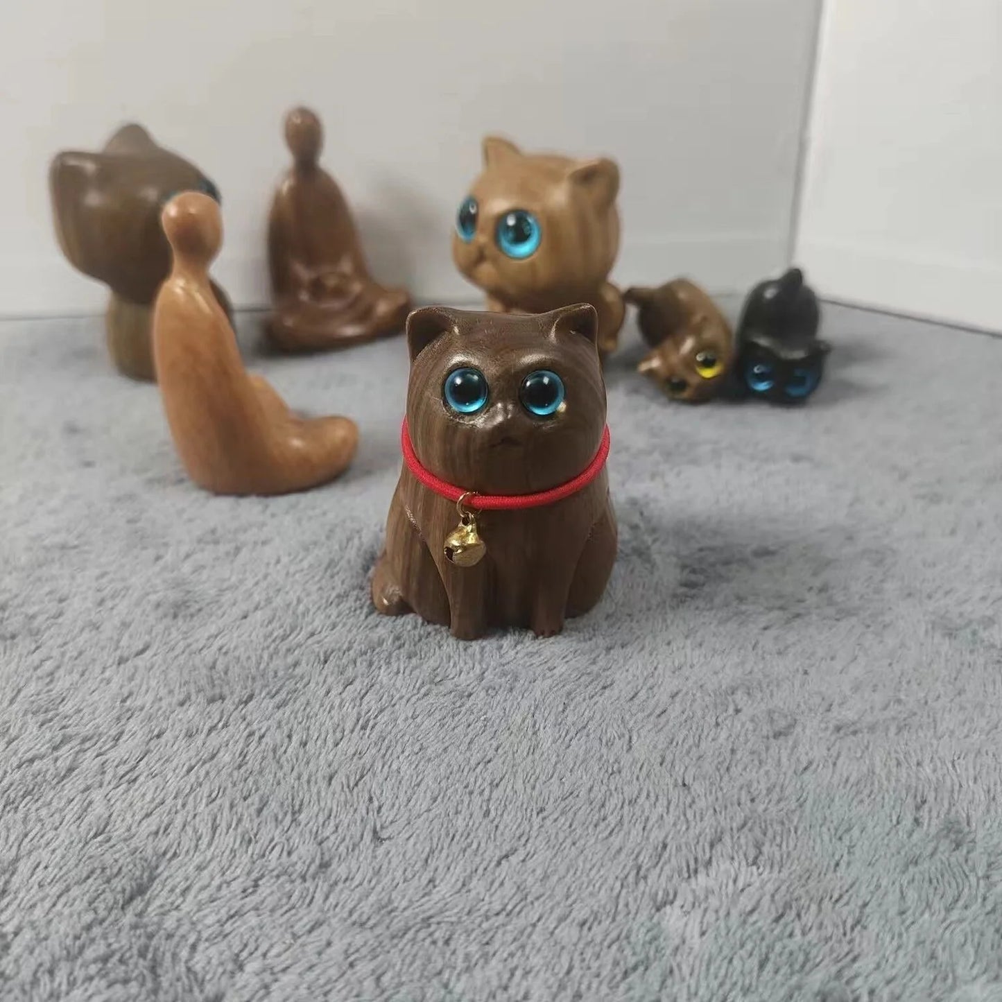 Handcrafted sandalwood kitten ornaments in various styles and colours