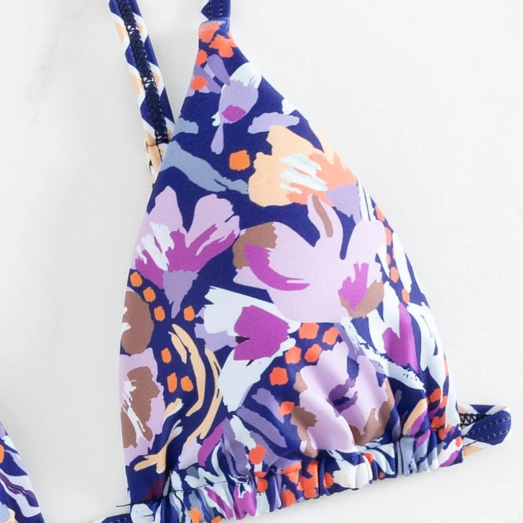 Women's floral print one-piece swimsuit with triangle bag design and split back in polyester.