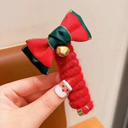 Festive Christmas hair ties for girls in various holiday-themed designs, including red bells, green trees, and khaki deer.