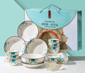 Flower In Ink 22-piece bone china tableware set with floral pattern, bowls, plates, and spoons on a table.