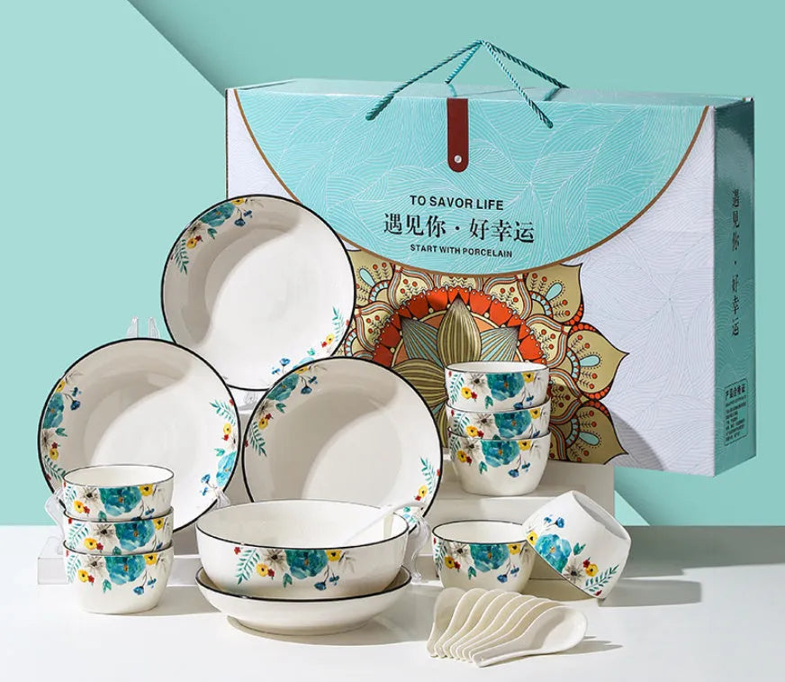 Flower In Ink 22-piece bone china tableware set with floral pattern, bowls, plates, and spoons on a table.