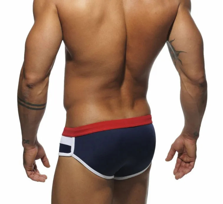 Men's nylon patchwork swim trunks in black with brief cut for swimming
