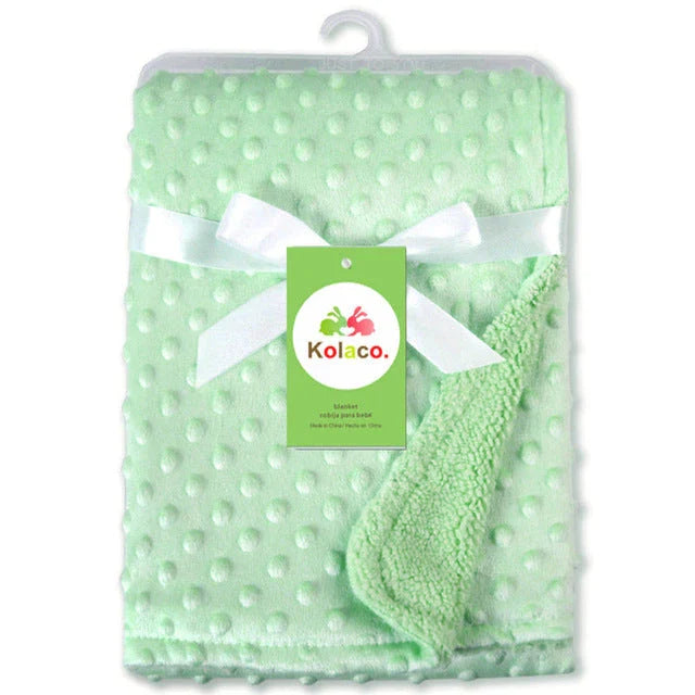 Soft and cozy baby blanket in various colors, including white, blue, gray, purple, green, and pink, with a plush, short-pile fabric and luxurious lamb velvet backing