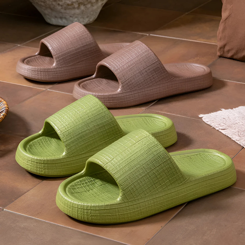 A pair of soft-bottom EVA bath slippers with a toe ring and non-slip sole, shown in one of five available colours.