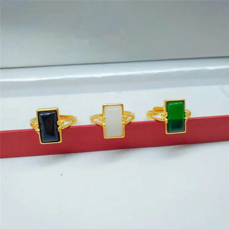 Adjustable brass gold-plated ring with a green gemstone set in a national style design.