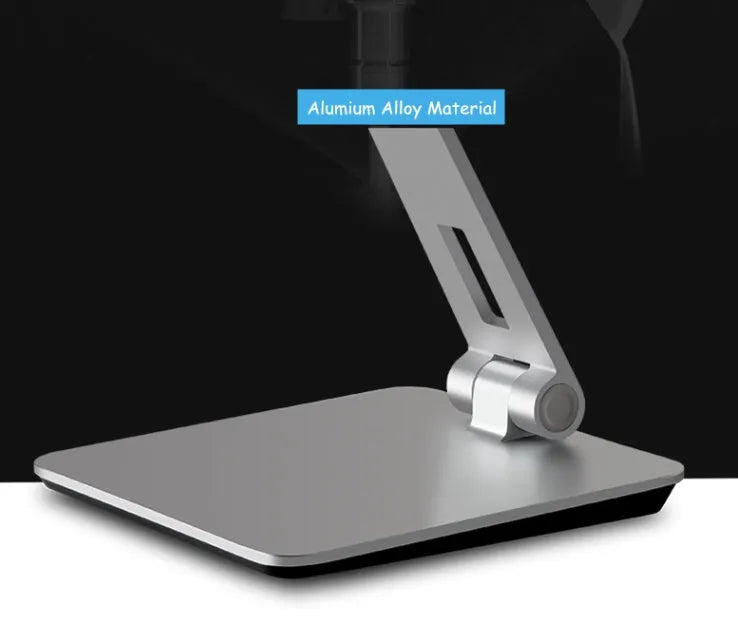Silver aluminium foldable desktop stand holding a tablet, showing 360-degree rotation.