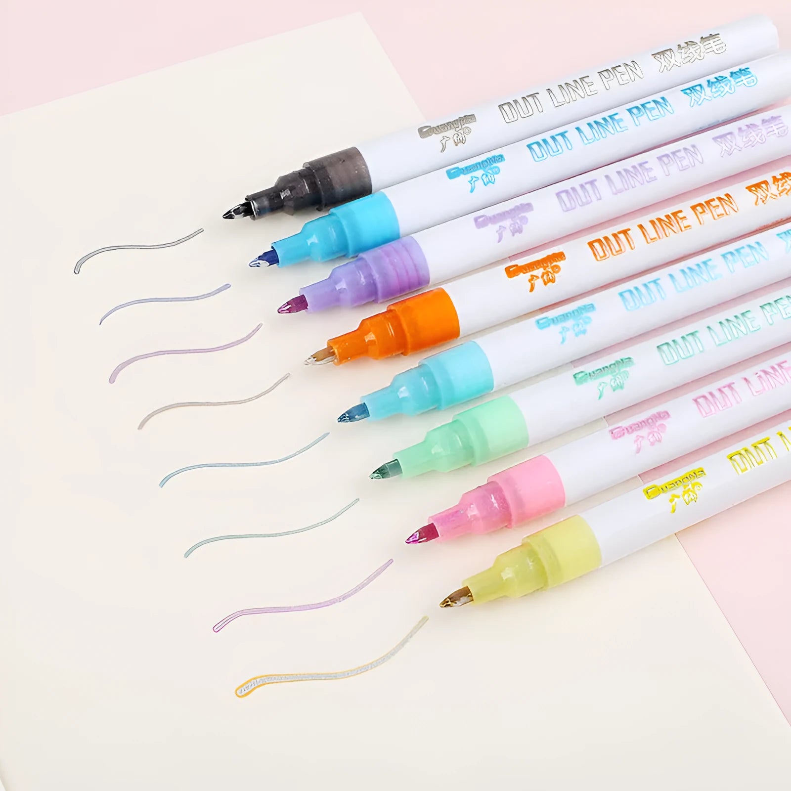 Eight fluorescent highlighter marker pens with transparent barrels and chisel tips arranged beside their 14cm packaging box