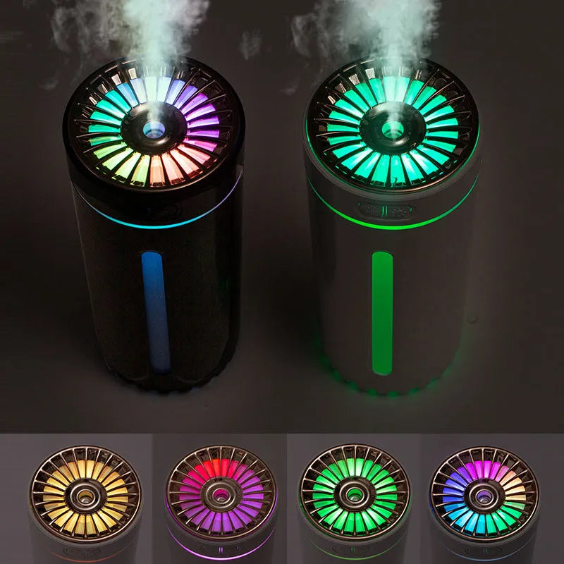 Compact black wireless USB humidifier with colourful LED lights on a car cup holder.