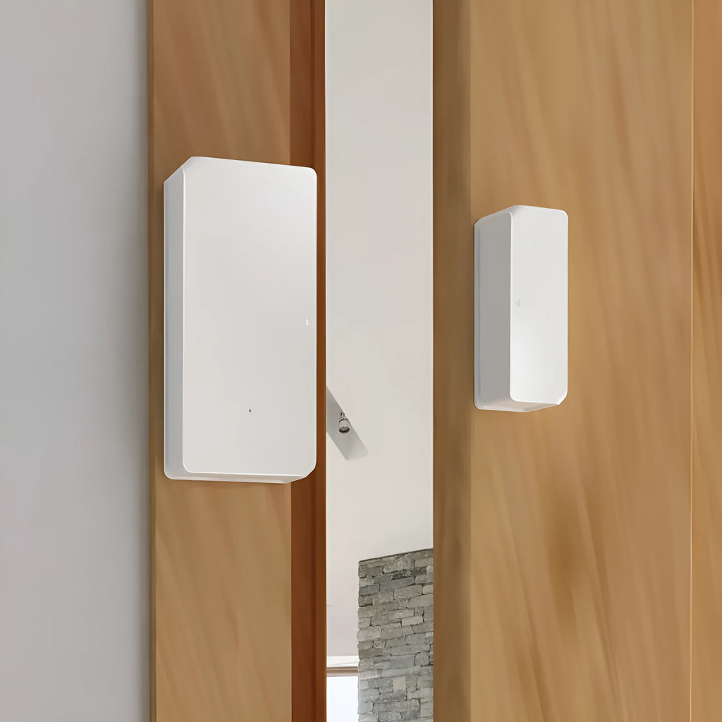 Wireless WiFi door and window sensor with white PC housing and adhesive strip for tool-free installation