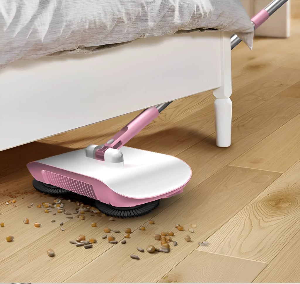 Pink hand push sweeper 3-in-1 with rotating brush on tiled floor
