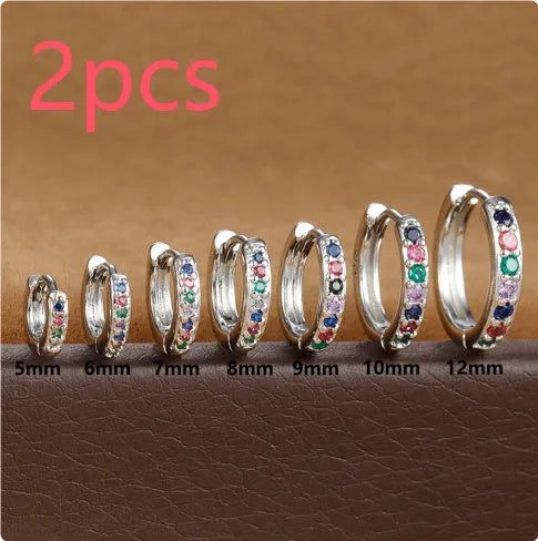 Gold, rose gold, and silver colour perforated circle zircon stud earrings in various sizes on a white background.