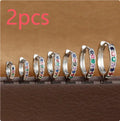 Gold, rose gold, and silver colour perforated circle zircon stud earrings in various sizes on a white background.