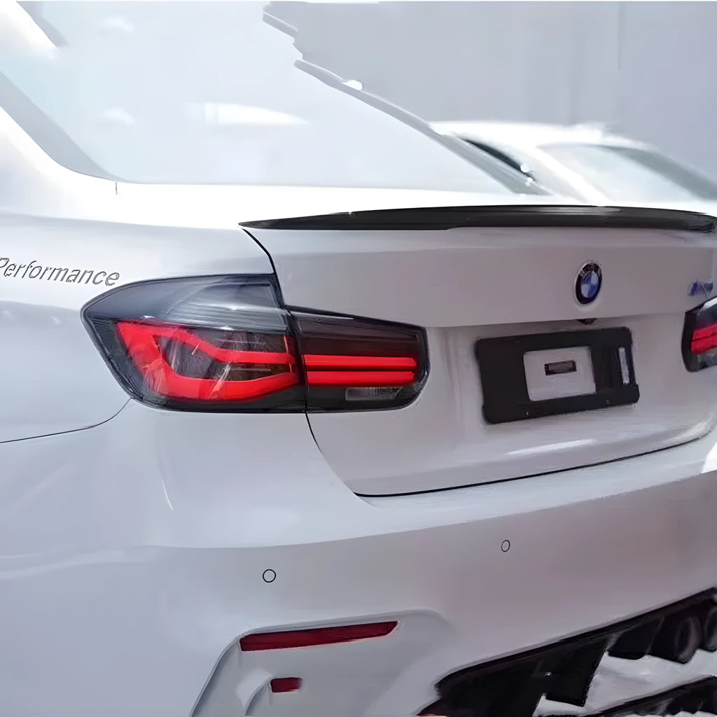 BMW 3 Series tail light assembly with LED running light strips in smoked black lens option