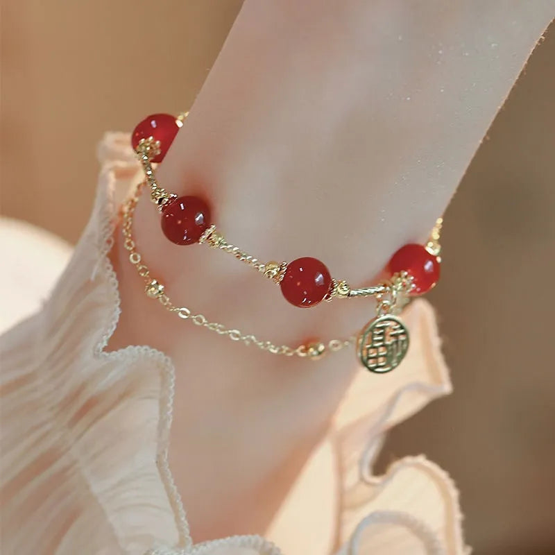 Red agate and alloy double-layer women's bracelet with a Red Horse blessing card charm on a white background.